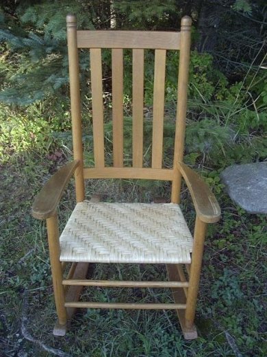 Handwoven splint seat in rocker.