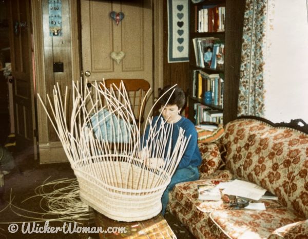 Cathryn Peters weaving wicker baby basinett. 