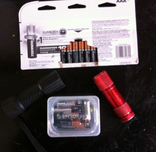 LED flashlight, AAA batteries and a plastic Gerber baby food tub that I store the batteries in. 
