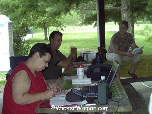 Foundering members sitting at picnic tables for the business meeting of The SeatWeavers' Guild at Robbins Crossing Village in Nelsonville, OH, July 2008.
