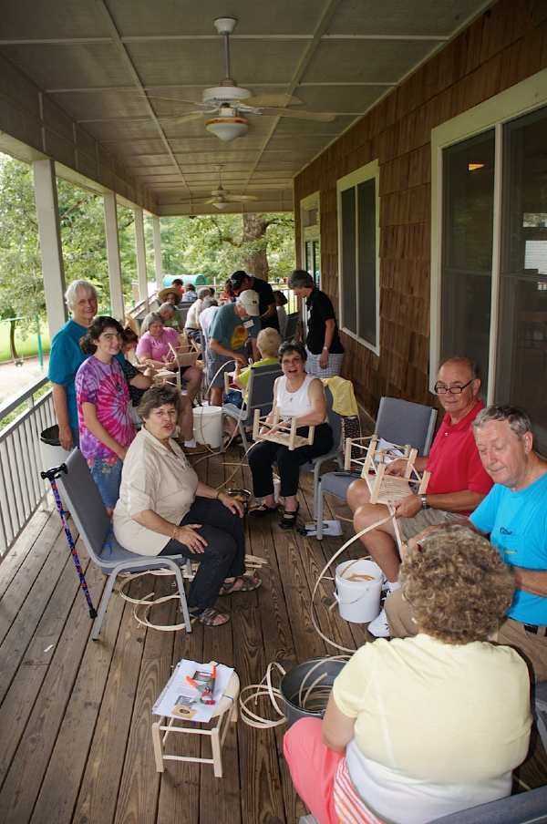 TSWG members demonstrating chair seat weaving 2013 Georgia Gathering