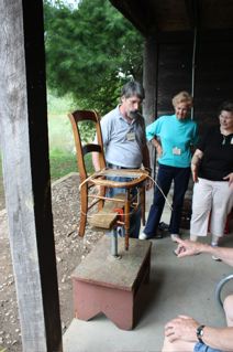 Bill Brick demonstrating a chair holding jig to make the chair caning job easier and more hands-free. 