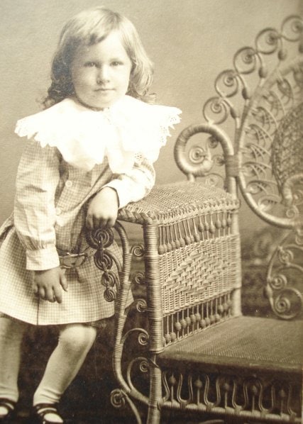 Picture "cabinet card" of a young boy posing on a very common Victorian wicker photographer's chair in the late 1890s-1900s 