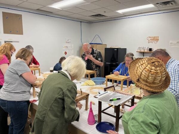 Hole cane footstool class with Professional Upholstery Association of Minnesota (PUAM) students.