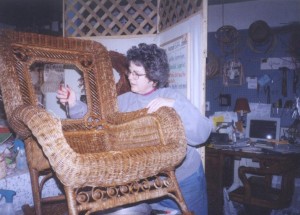 Cathryn repairing Victorian reed wicker rocker with serpentine arms and Star of David cane weave in the back. 