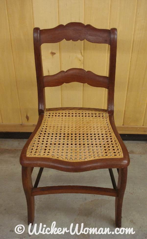 Hole-to-hole cane chair seat with a horseshoe shape. 