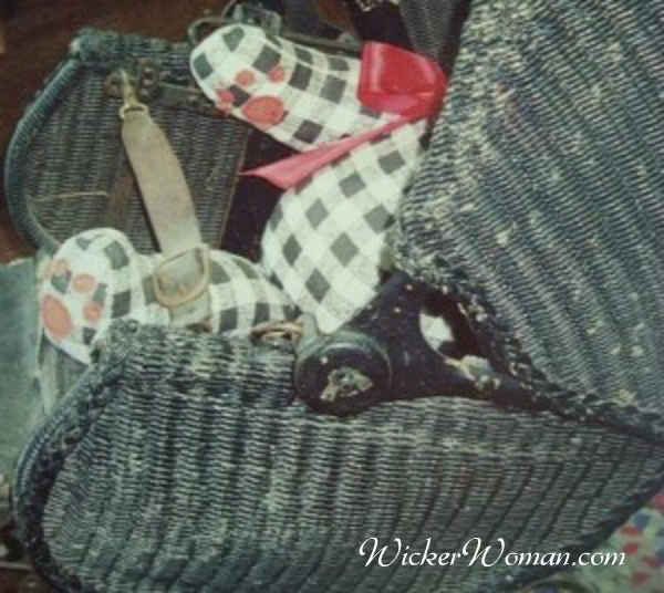 1920s Lloyd Loom wicker baby cart with a checkered black & white teddy bear in the seat. 