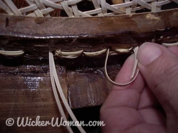 Cane tail going wrong way for no-knot chair caning technique. 