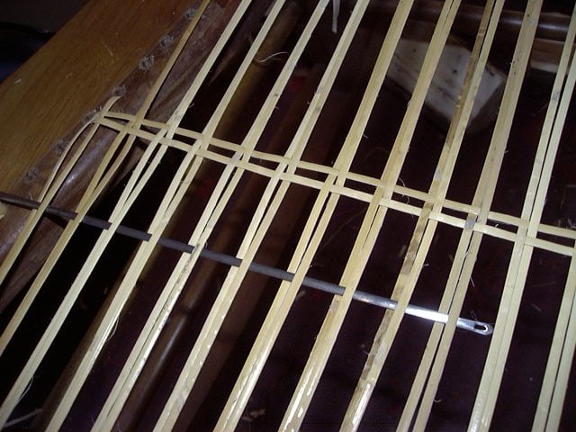 English chair caning needle in use on a hole-to-hole cane seat. 

