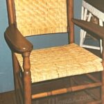 Wide binding cane arm chair with both seat and back woven in 4x4 twill pattern.