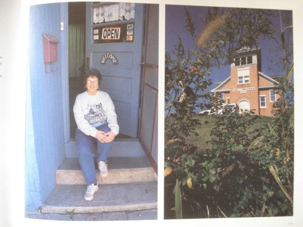 Photo from the book,Small Town Minnesota A to Z, by Tony Andersen, featuring Cathryn Peters on steps of The Wicker Woman on the left, and the old 1800s Zumbro Falls brick schoolhouse on the right. 