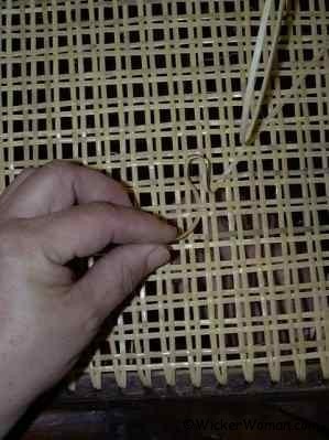 Traditional hole-to-hole strand chair caning.