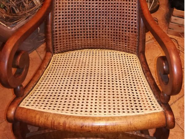 Traditional hole-to-hole chair caning in Lincoln rocker, done by Walnut Hollow Caning in Athens, Tennesee
