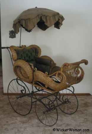 Fancy Victorian wire-wheel reed wicker perambulator upholstered interior with original umbrella by the Tillman Manufacturing Company.