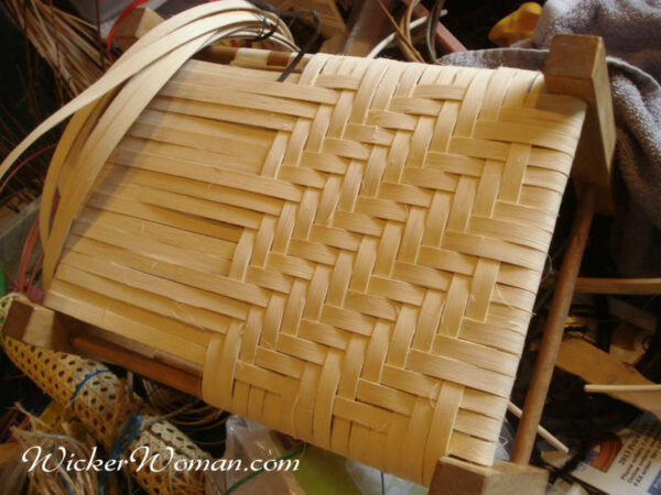 Woven reed footstool in process